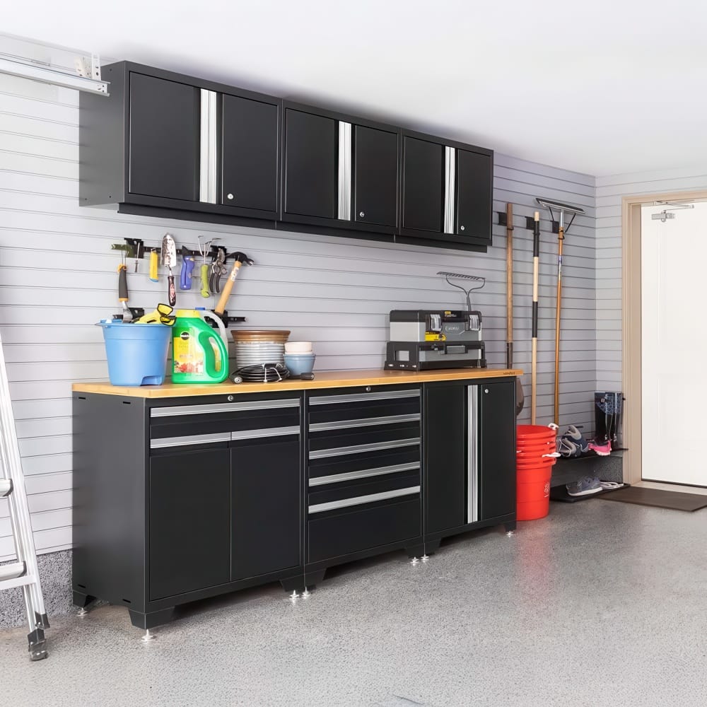 Garage Cabinet Set With Wood Countertop Displays Cleaning Supplies Tool Storage And Garden Equipment Along A Gray Slatwall Near A Door