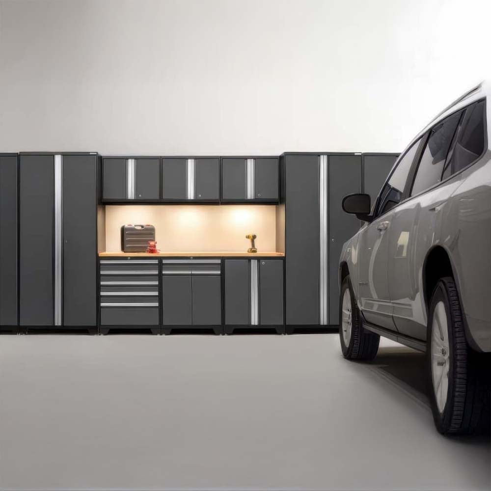 Garage With Illuminated Workbench And Dark Cabinets As A SUV Is Parked To The Right