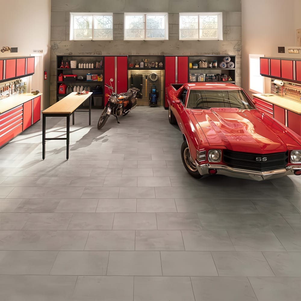 Garage With Red Muscle Car Motorcycle Center Work Table And Red Storage Cabinets Along Both Walls