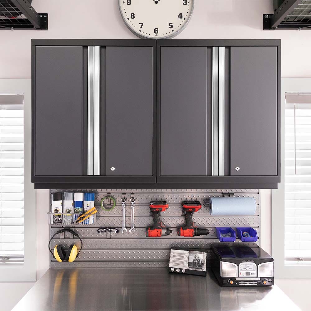 Garage Workspace Shows Wall Cabinets Over A Slatwall Organized With Tools Sprays And Cordless Drills Above A Stainless Worktop