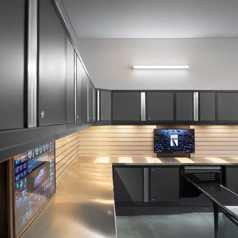Garage Workstation With Dark Cabinets Stainless Countertops And Dual Wall Mounted Monitors