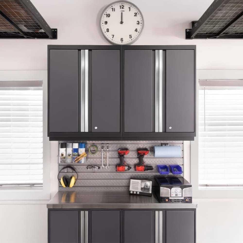 Garage Workstation With Gray Wall Cabinets Clock Overhead Pegboard Tools And Stainless Worktop Between Two Windows
