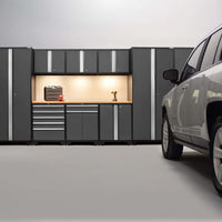 Garage Workstation With Illuminated Wood Top Surface Flanked By Tall Cabinets Drawers