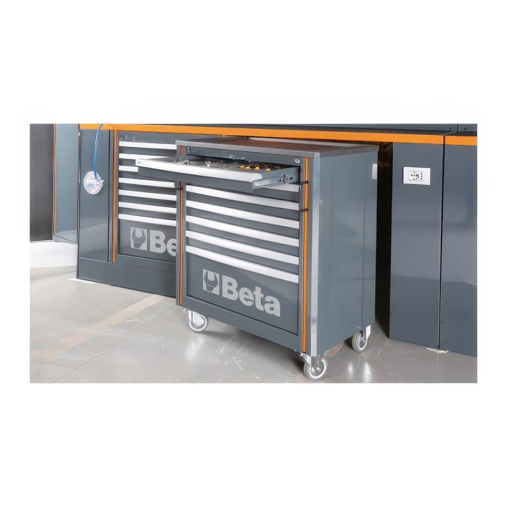 Gray Beta Rolling Tool Cabinet Pulled Out From A Modular Workbench With An Open Top Drawer And Matching Storage Units