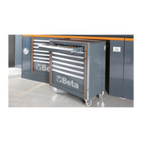 Gray Beta Rolling Tool Cabinet Pulled Out From A Modular Workbench With An Open Top Drawer And Matching Storage Units