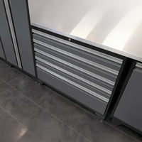 Gray Metal Tool Cabinet With Six Drawers Built Into A Workbench Setup