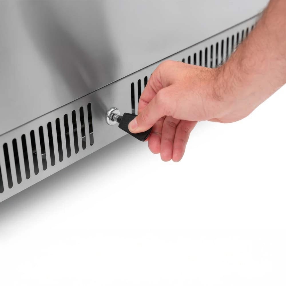 Hand Inserts Key Into Lock On Vented Stainless Steel Appliance Panel