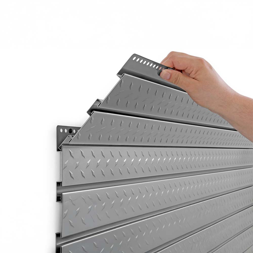 Hand Installing A Diamond Plate Slatwall Panel Onto A Mounted Hanging Rail