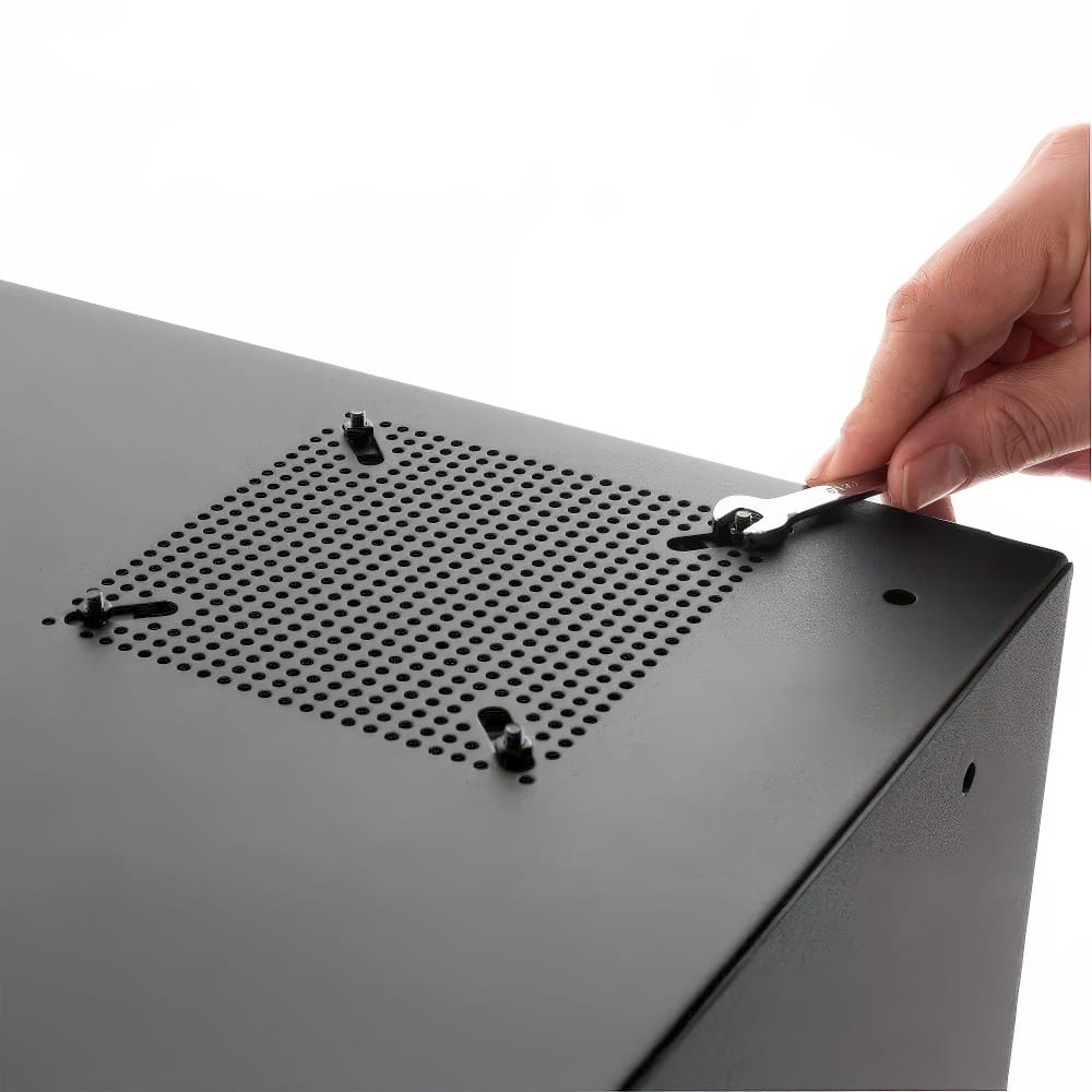 Hand Using A Wrench To Tighten Bolts On A Perforated Metal Panel Of A Black Cabinet
