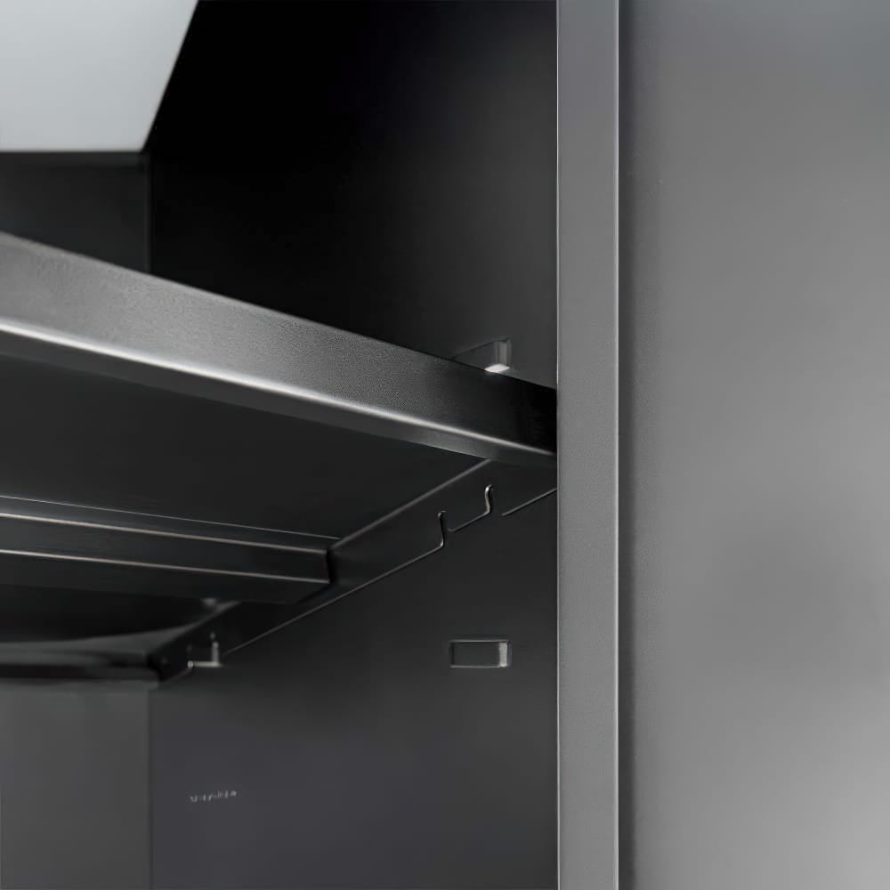 Interior Corner Of A Matte Black Metal Cabinet Featuring An Adjustable Steel Shelf And Integrated Utility Hooks