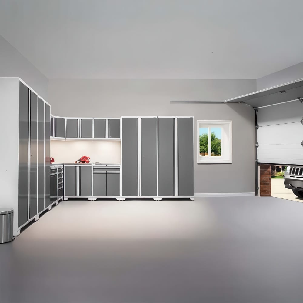 L Shaped Grey Cabinet System Along The Wall And An Open Overhead Door Showing A Parked SUV