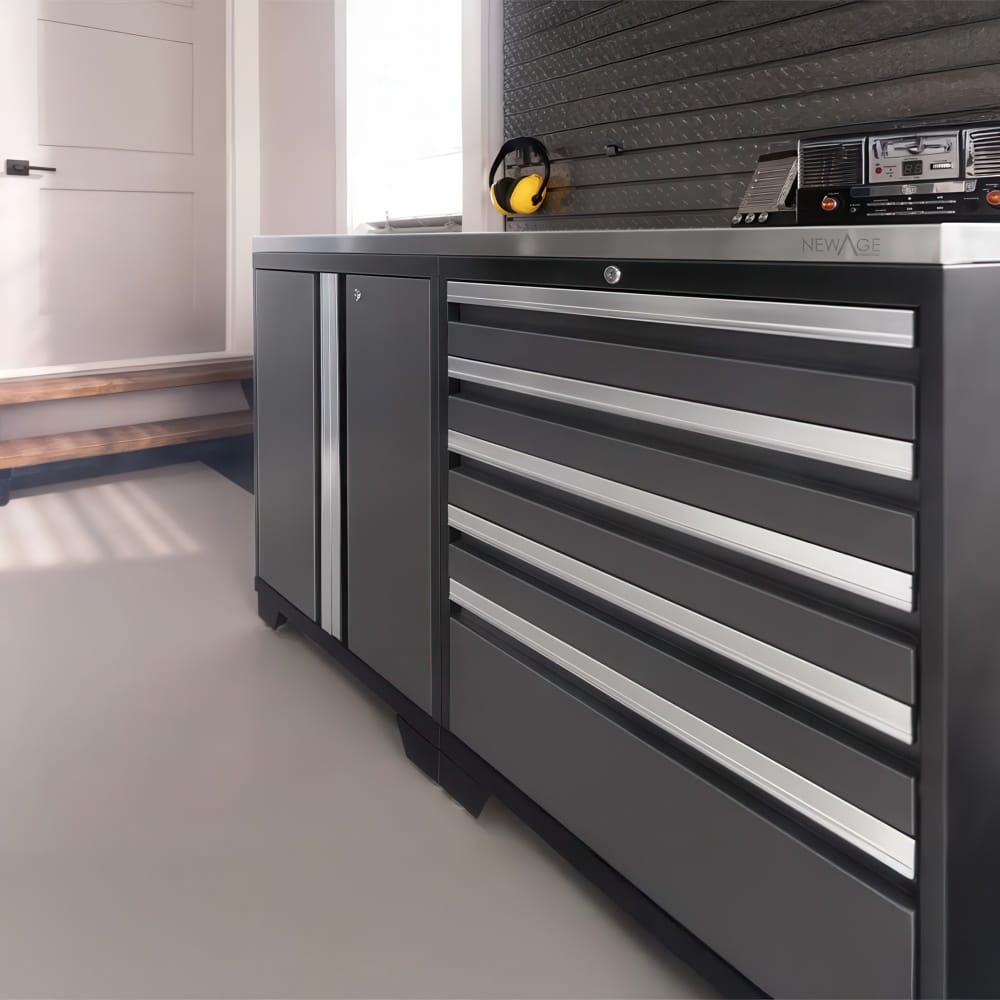 Low Angle View Of Modern Garage Base Cabinet With Multiple Drawers And Steel Countertop Near Doorway