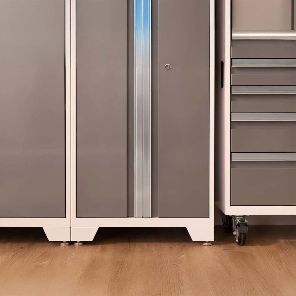 Lower Portion Of A Set Of Garage Storage Units Including A Tall Cabinet With Double Doors And A Vertical Metallic Handle Flanked By A Drawer Cabinet On Casters