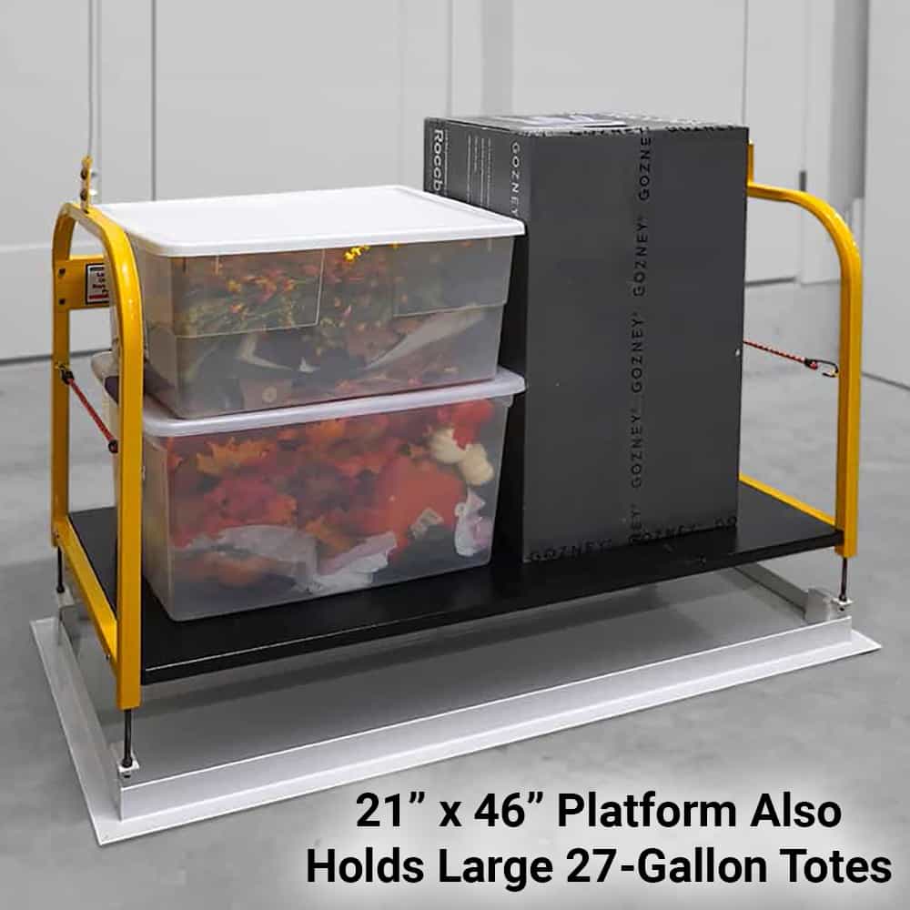 Majic Attic Lift platform loaded with two large storage totes and a box, lowered to the floor