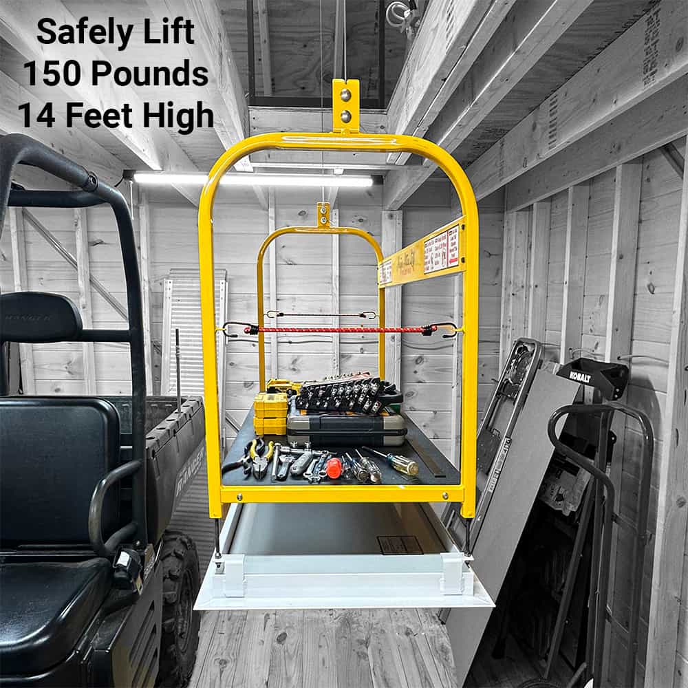 Majic Attic Lift lowered in a garage, carrying a load of tools