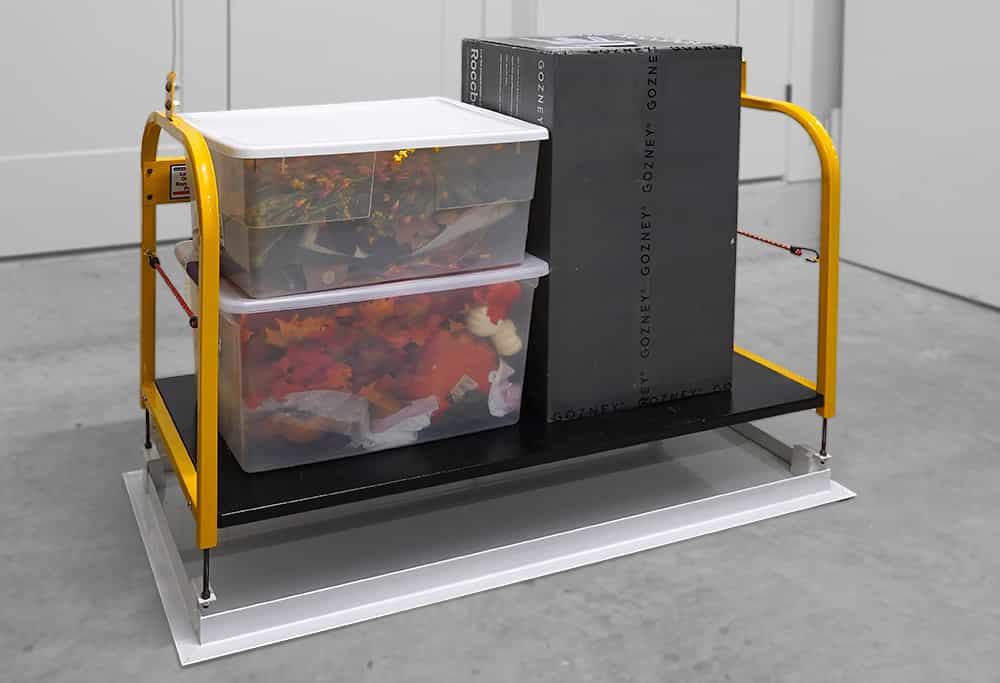 Majic Attic Lift System Platform Loaded With Totes and Box Lowered to Floor