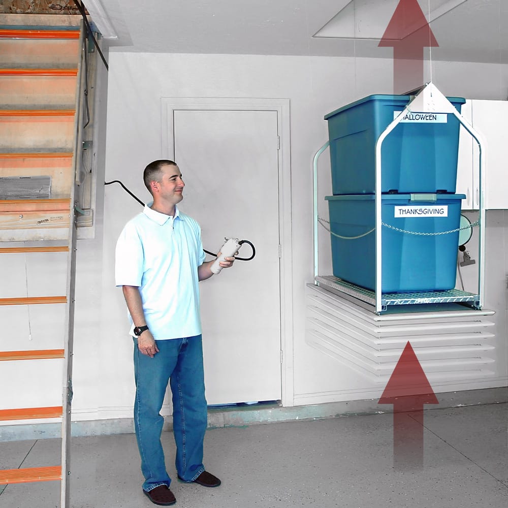 Man Holding A Remote Control Using VersaLift Attic With Storage Bins