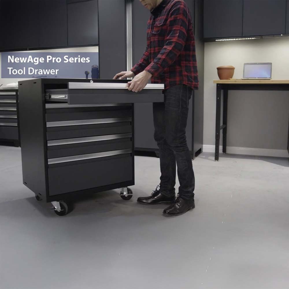 Man Pulling Open Drawer On Black Rolling Tool Cabinet In Modern Garage Workspace