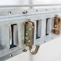 Metal Hook Attached To A Metal Equipment Case Part Of Electric Lifts For Garage Storage By AuxxLift