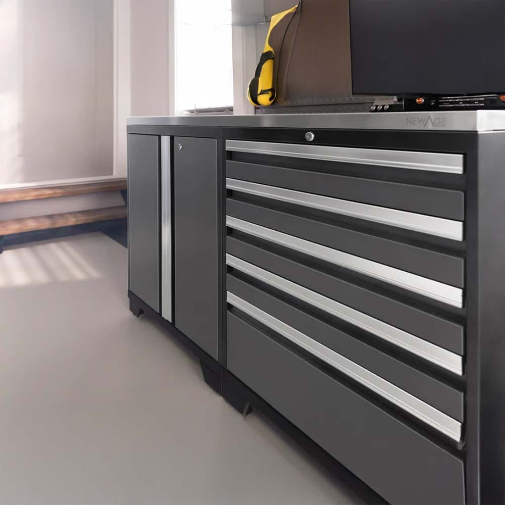 Modern Black Tool Cabinet With Multiple Drawers And A Side Compartment Sits In A Well-Lit Garage Corner