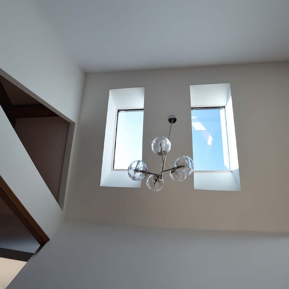 Modern Ceiling View With Double Skylight Windows And Hanging Glass Ball Light Fixture
