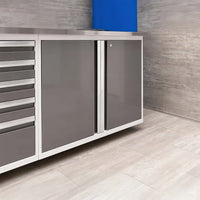 Modern Garage Cabinet With Grey Double Doors And Adjacent Drawer Unit Featuring Stainless Steel Worktop