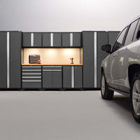 Modern Garage With Illuminated Grey Cabinets A Workbench And A White SUV Parked 
