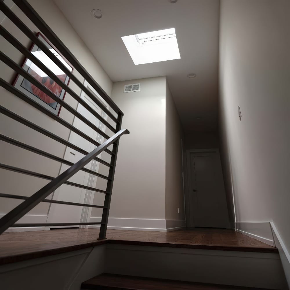 Modern Staircase Hallway With Wooden Flooring And Ceiling Skylight