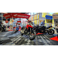 Motorcycles All Set On A Sleek Checkered Black And White Race Deck Flooring With Ample Natural Lighting From Large Windows