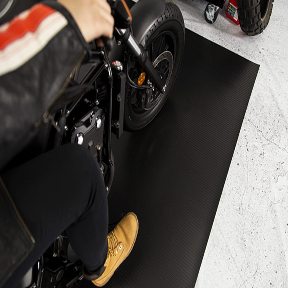 Motorcycles Rear Wheel Positioned On A Textured Black Garage Motorcycle Mat