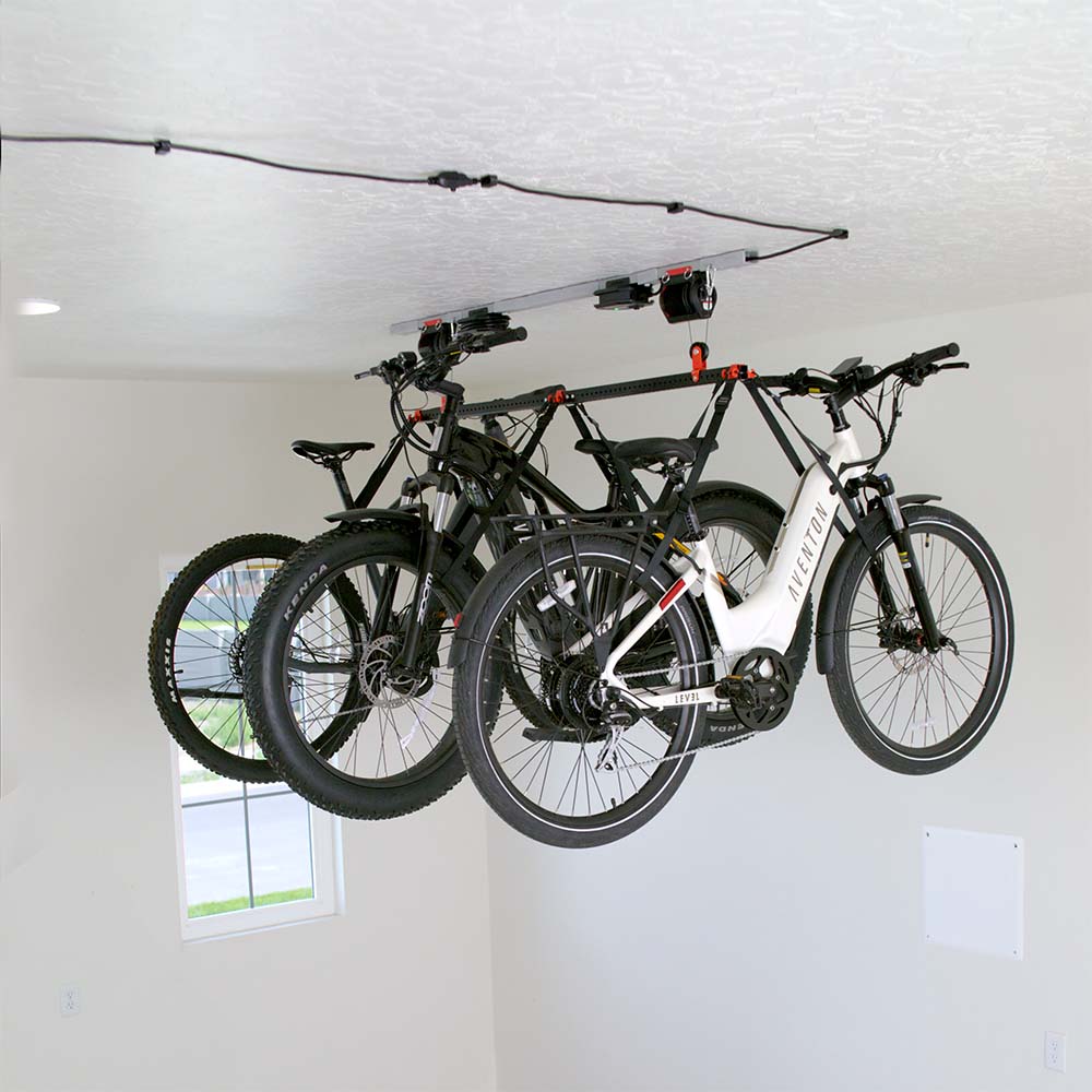 Multiple Bicycles Suspended From The Ceiling On A Garage Smart Bike Lift