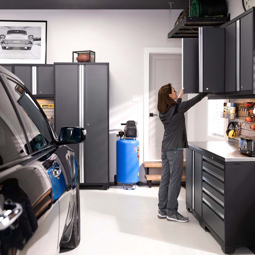 NewAge 14 Piece Garage Cabinet Set Pro 3.0 Series And A Person Reaches Up To Access An Upper Cabinet