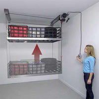 Woman operating ONRAX motorized garage storage lift system with key lock control, lifting platform loaded with storage bins