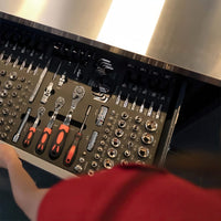 Open Drawer Shows Meticulously Organized Socket Set Ratchets And Hex Keys Beneath A Stainless Worktop As A Person Reaches In