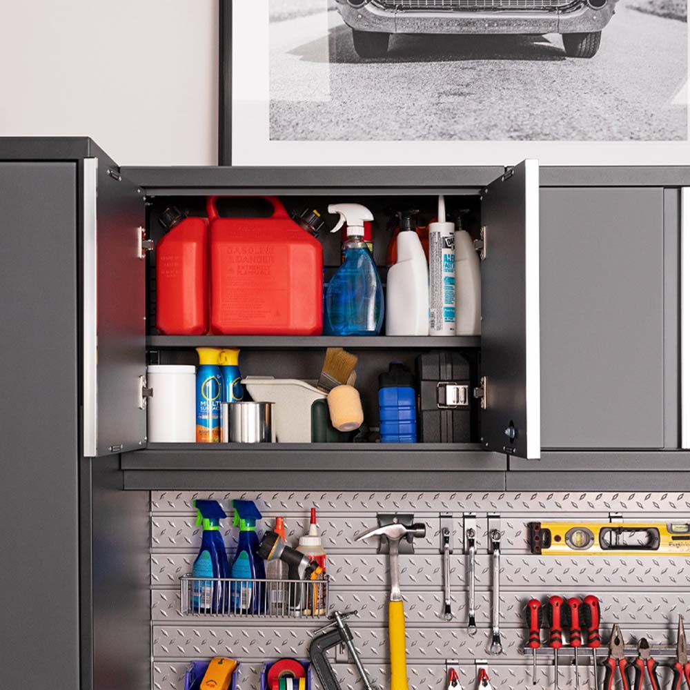 Open Upper Garage Cabinet Stuffed With Fuel Cans And Cleaners Sits Above A Diamond Plate Tool Wall With Sprays Hammer And Screwdrivers