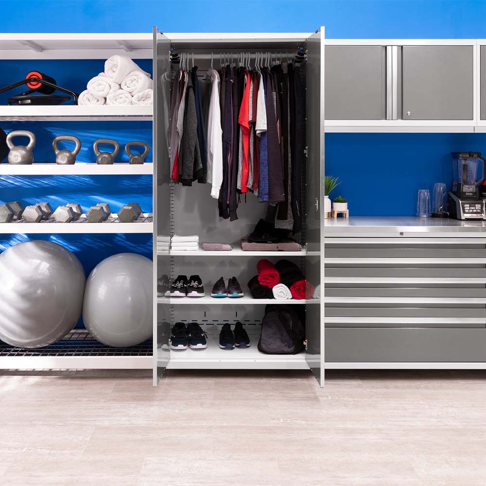 Organized Gym Wardrobe Cabinet Filled With Workout Clothing Shoes And Towels Between Equipment Shelves And Stainless Worktop