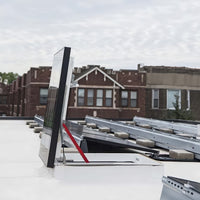 Partially Open Roof Hatch With Glass Top And Red Support Bar On White Rooftop