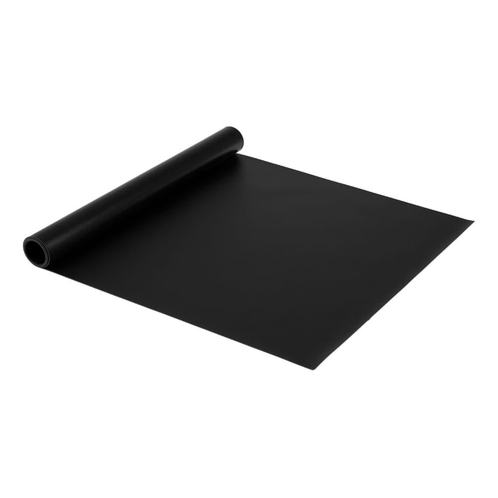Partially Unrolled G-Floor Equipment Mat Black Sheet Of Material With A Smooth Texture Lying Flat On A White Surface