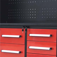 Pegboard Backpanel Above Red Drawers With White Handles And Keys