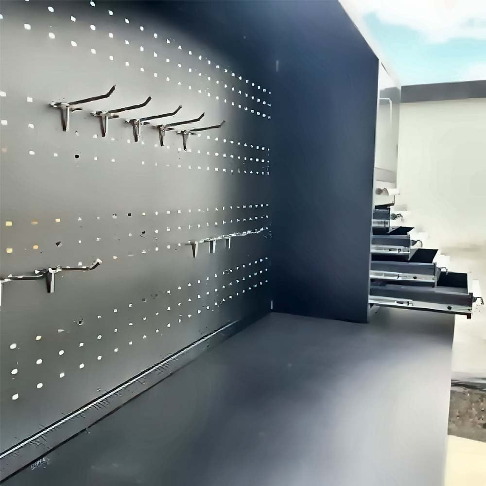 Pegboard Workbench Hutch With Metal Hooks Installed And Several Drawers Pulled Open