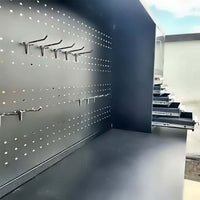 Pegboard Workbench Hutch With Metal Hooks Installed And Several Drawers Pulled Open
