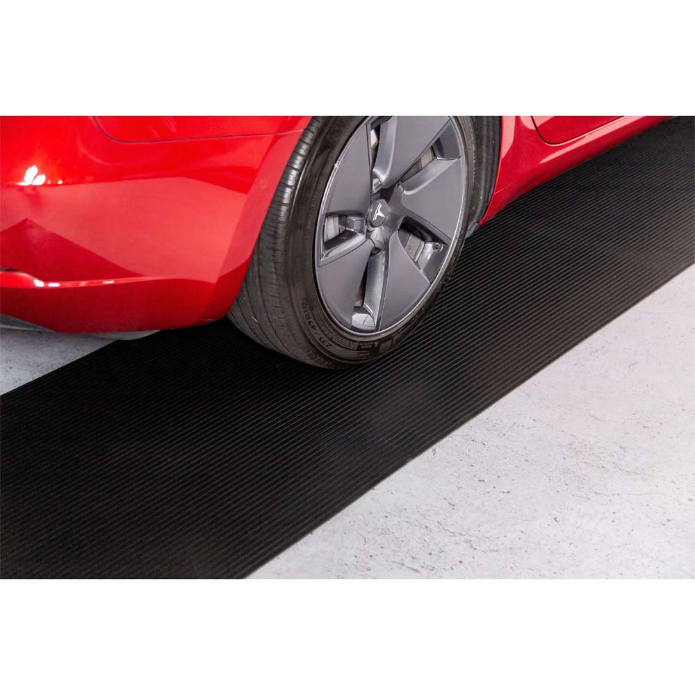 Red Cars Front Wheel And Tire Positioned On A Black Ribbed G-Floor Garage Floor Mats