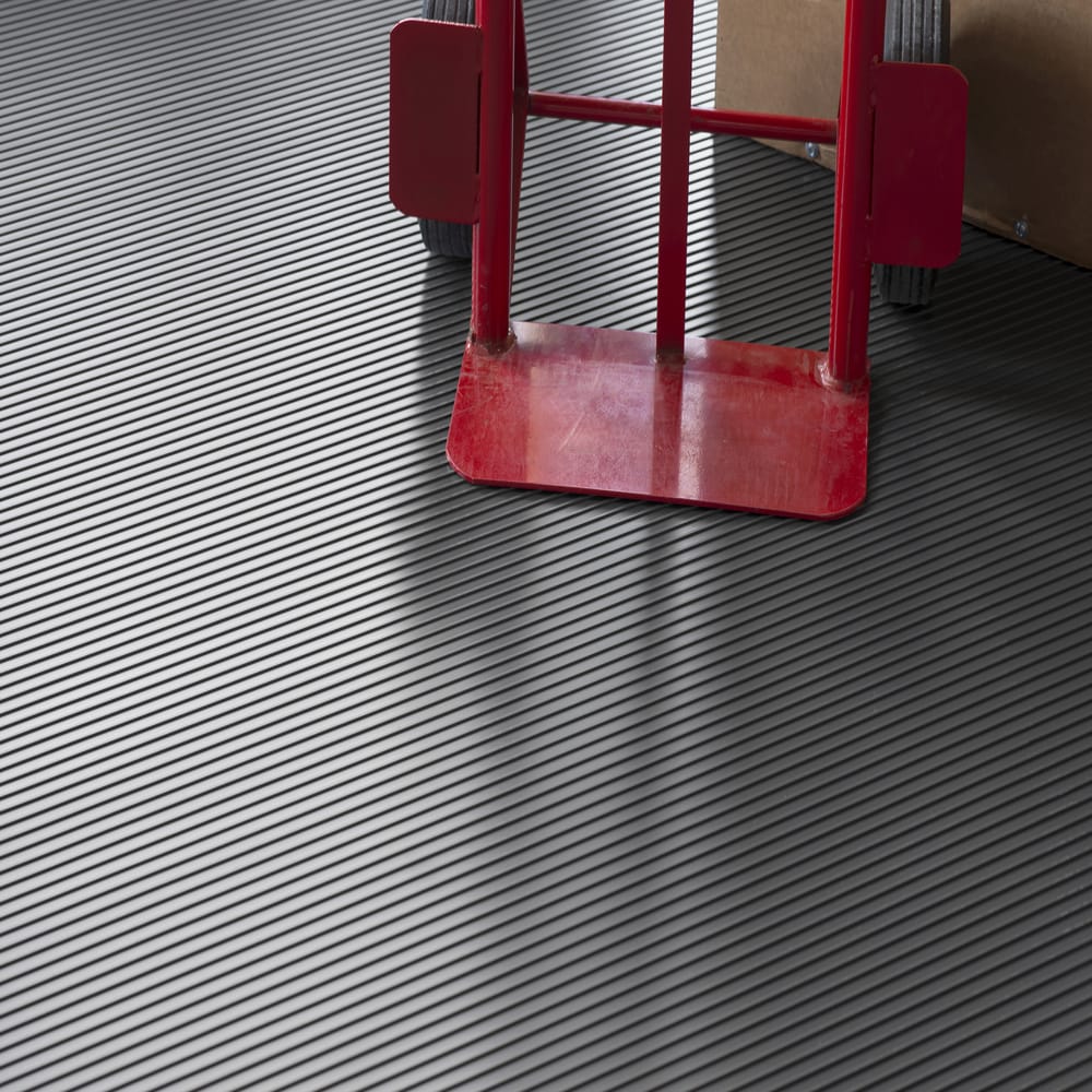 Red Metal Frame And Wheels Positioned On A G-Floor Vinyl Flooring With A Textured Diagonal Striped Pattern
