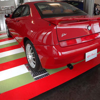 Red Sports Car Parked On A Red And Green Striped Race Deck Accupark In A Showroom