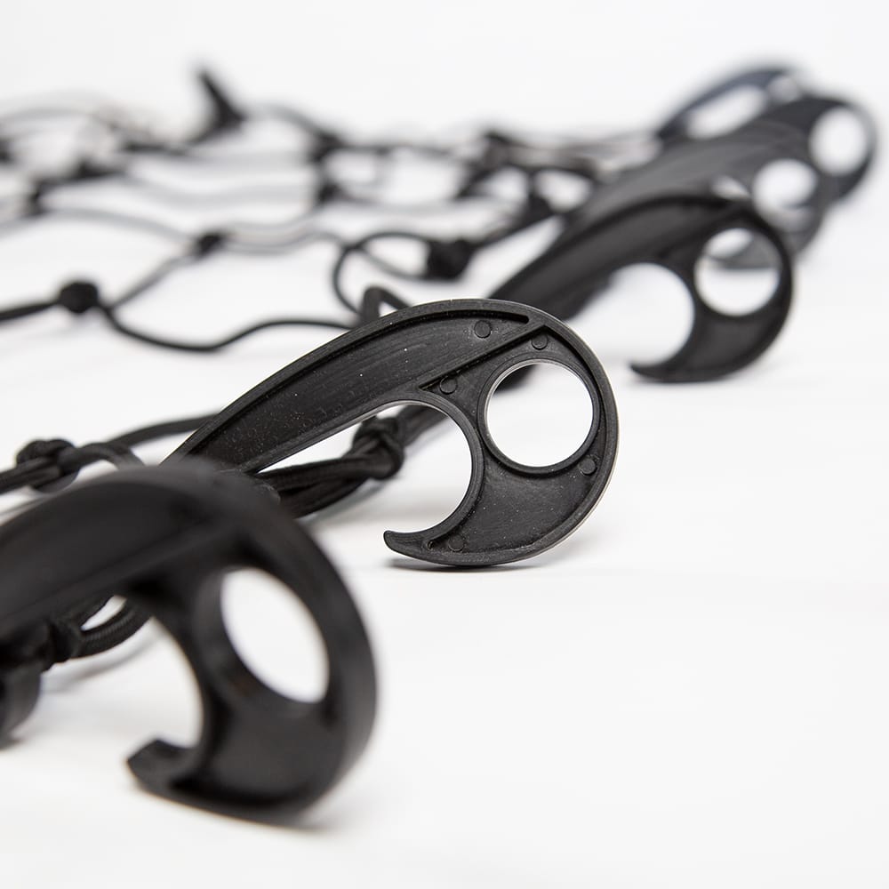 Several Black Plastic Hooks Designed With Dual Loops Connected To A Stretchable Netting System