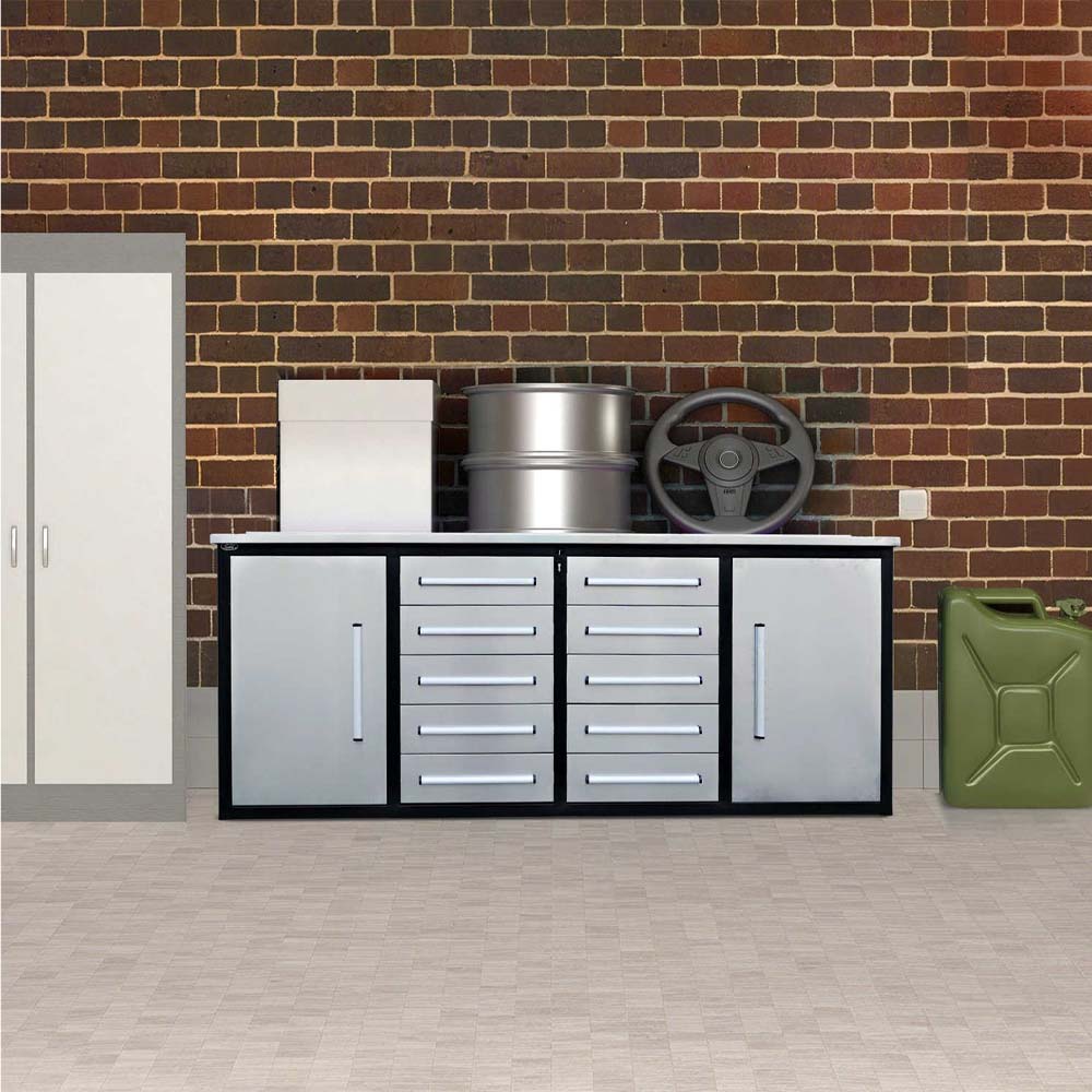 Silver And Black Drawer Workbench Sits Against A Brick Wall