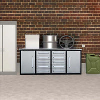 Silver And Black Drawer Workbench Sits Against A Brick Wall