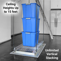 Garage lift platform with three stacked blue storage totes, lowered to a concrete garage floor