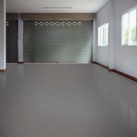Spacious Empty Area Featuring A Closed Metal Roller Shutter Door, Perfection Tile Best Garage Floor Tiles And Several Windows