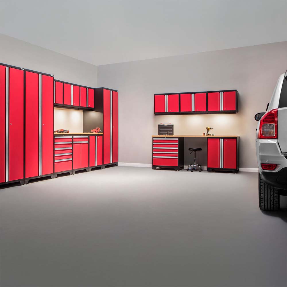 Spacious Garage With Matching Red Cabinet Sets Lighted Workstations And A Parked SUV On The Right